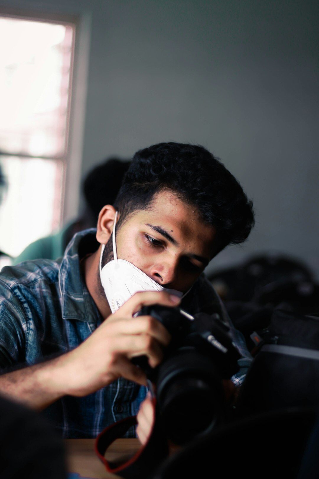 Portrait of a young male photojournalist with a camera